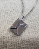 Pendant in the shape of an envelope with a letter inside Love You